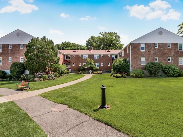 view of home's community with a lawn