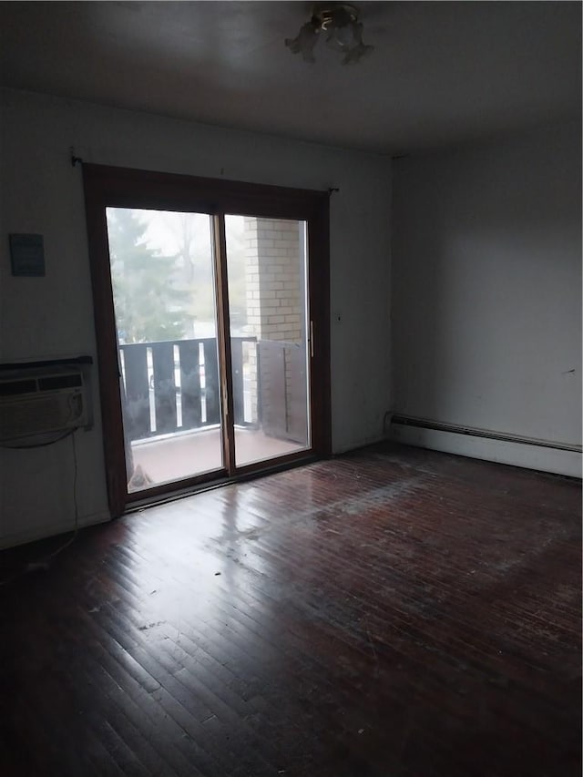 unfurnished room featuring baseboard heating, dark hardwood / wood-style flooring, and a wall mounted air conditioner