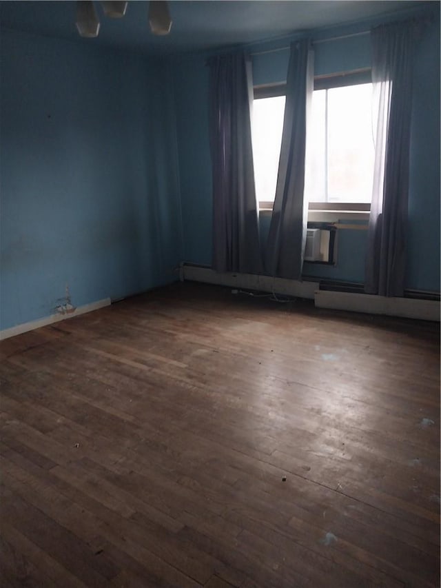 empty room with dark hardwood / wood-style flooring