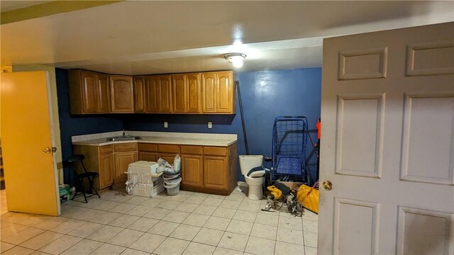 kitchen with light tile patterned flooring and sink