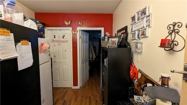 kitchen featuring white refrigerator and dark hardwood / wood-style flooring