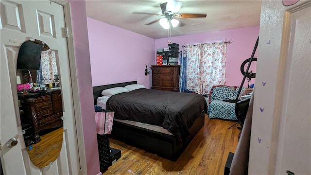 bedroom with light wood-type flooring and ceiling fan