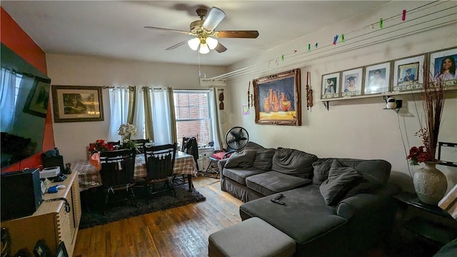 living room featuring ceiling fan and wood-type flooring