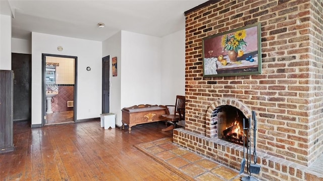 living room featuring hardwood / wood-style floors and a brick fireplace