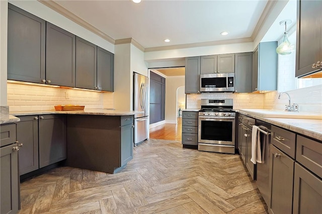 kitchen with gray cabinetry, light stone countertops, tasteful backsplash, light parquet floors, and appliances with stainless steel finishes