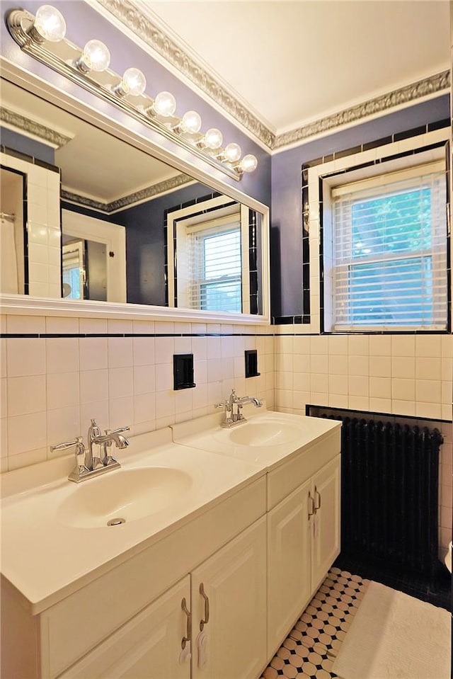 bathroom featuring vanity, backsplash, radiator, tile patterned floors, and tile walls