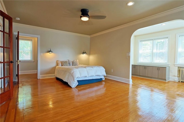 bedroom with light hardwood / wood-style flooring, multiple windows, and ceiling fan