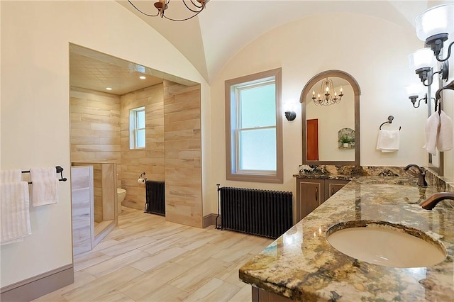 bathroom featuring toilet, radiator heating unit, vanity, and an inviting chandelier