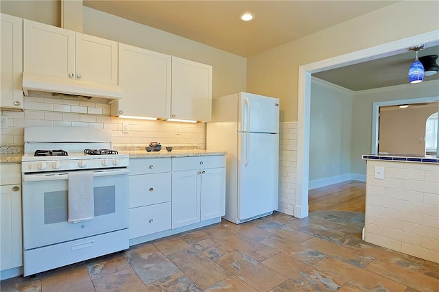 kitchen with light stone countertops, white appliances, decorative light fixtures, and white cabinetry