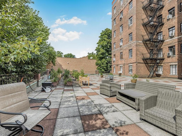 view of patio with an outdoor living space and cooling unit