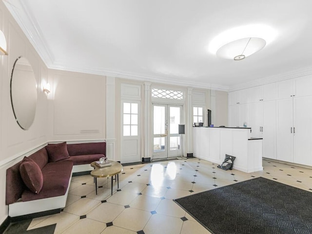 living room featuring french doors and crown molding