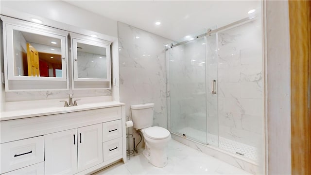 bathroom with a shower with door, vanity, and toilet