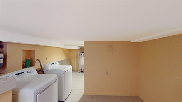 laundry room with light tile patterned floors, gas water heater, and washer and clothes dryer