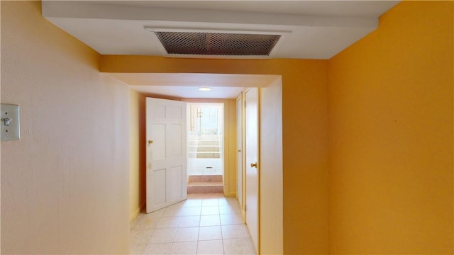 corridor featuring light tile patterned floors