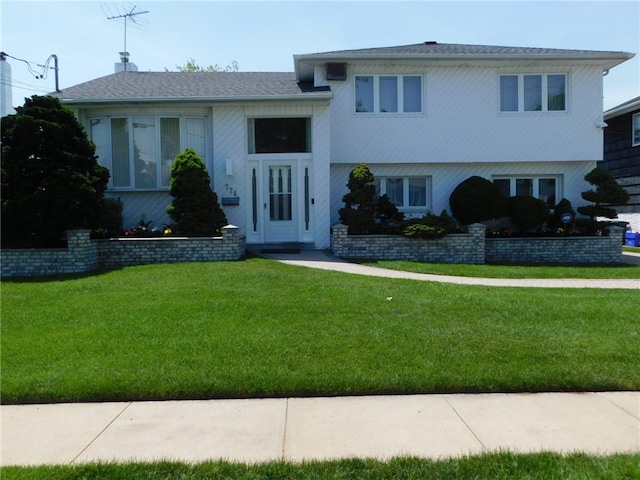 split level home with a front lawn