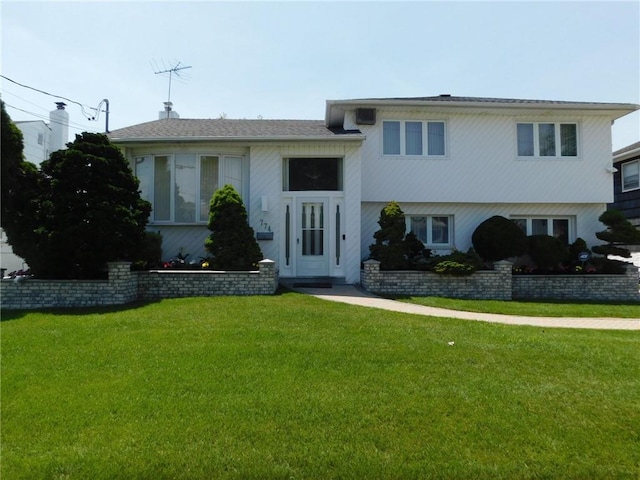 tri-level home with a front yard