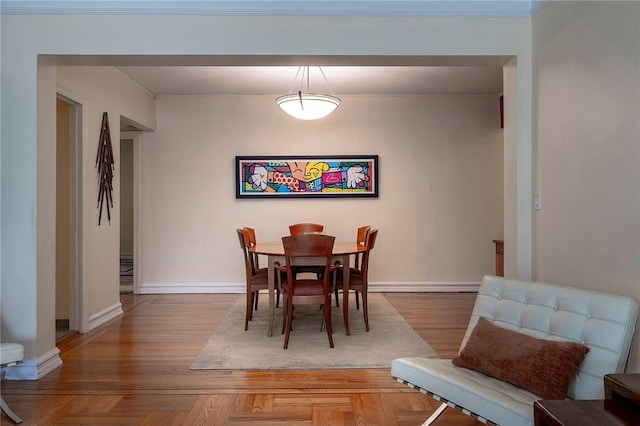 dining space featuring crown molding