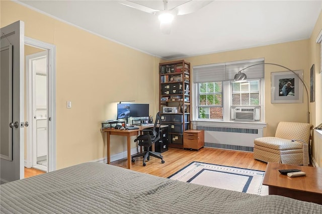 office area with cooling unit, light hardwood / wood-style flooring, radiator, and ornamental molding