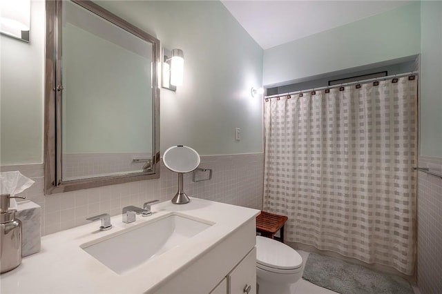 bathroom featuring a shower with shower curtain, vanity, toilet, and tile walls