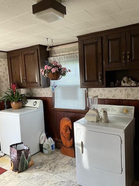 washroom featuring separate washer and dryer and cabinets