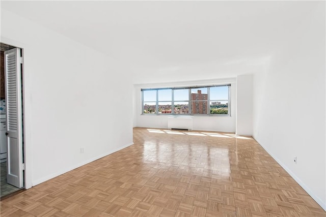 unfurnished room featuring baseboards