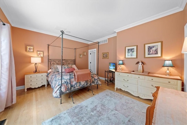 bedroom with ornamental molding and light hardwood / wood-style flooring