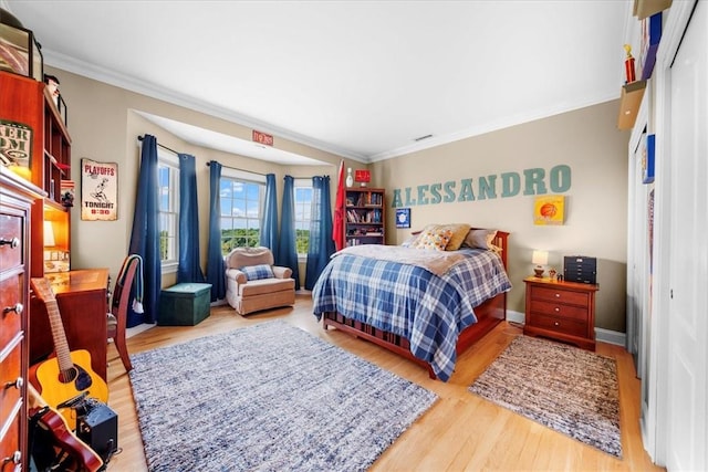 bedroom featuring wood-type flooring and ornamental molding