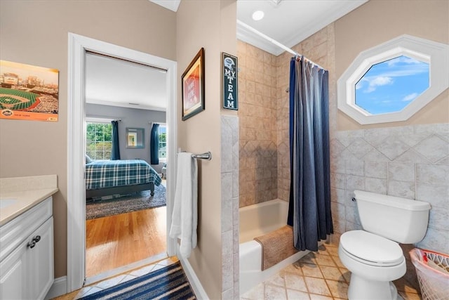 full bathroom featuring vanity, hardwood / wood-style floors, shower / bath combo, and crown molding