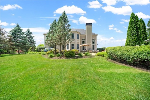 rear view of property with a lawn