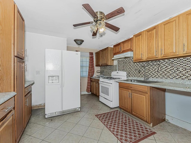 kitchen featuring decorative backsplash, light tile patterned flooring, white appliances, and sink