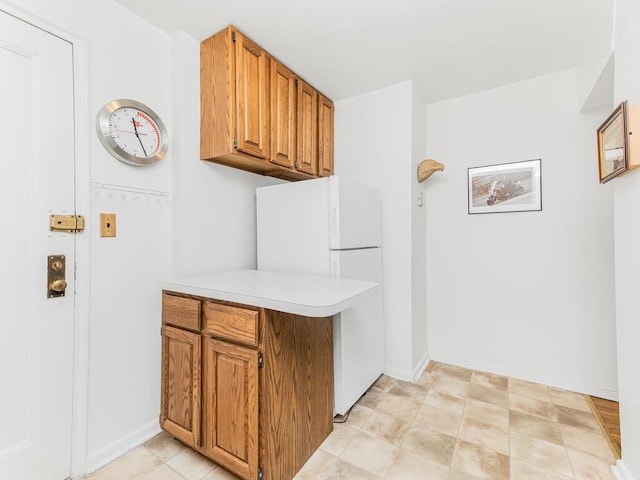 kitchen featuring light tile patterned floors and white refrigerator