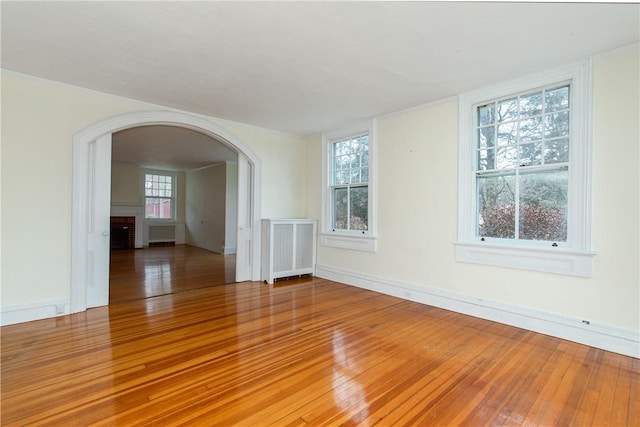 spare room featuring hardwood / wood-style floors and radiator