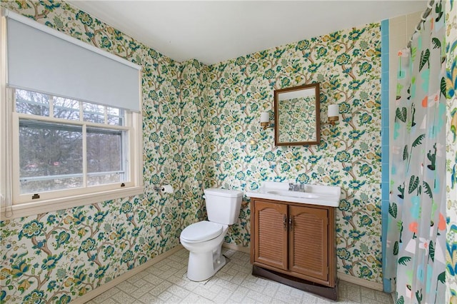 bathroom with vanity, toilet, and walk in shower