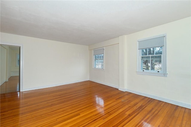 spare room with hardwood / wood-style floors