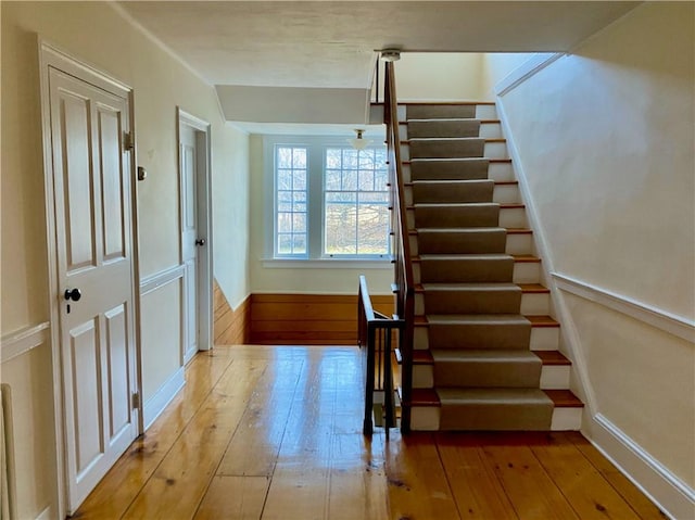 stairway with hardwood / wood-style flooring