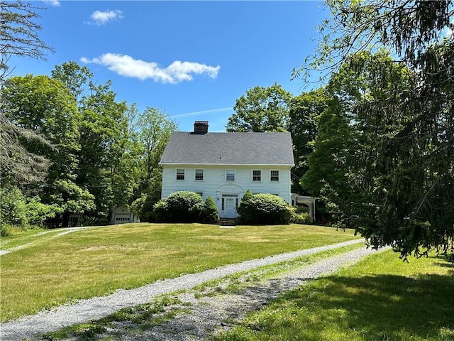 back of house with a lawn