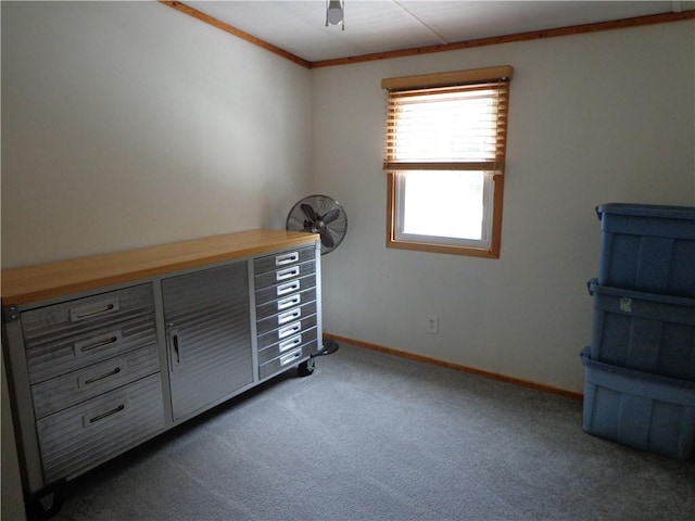 unfurnished bedroom with ceiling fan, crown molding, and dark carpet