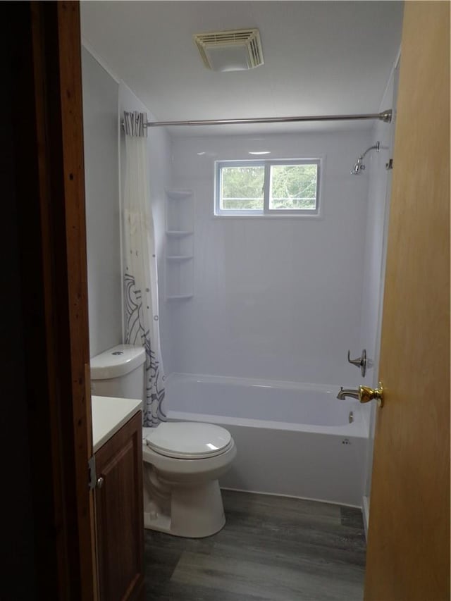 full bathroom with hardwood / wood-style floors, vanity, toilet, and shower / tub combo