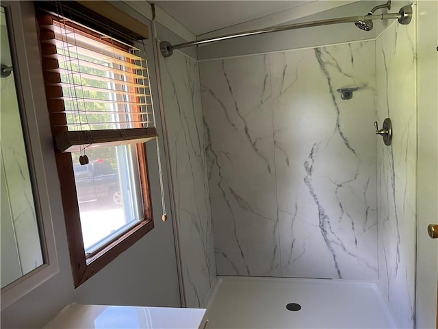 bathroom with a tile shower