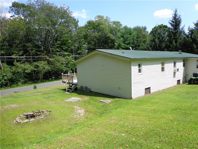 view of side of property with a lawn and a deck