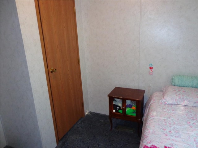 bedroom with dark colored carpet