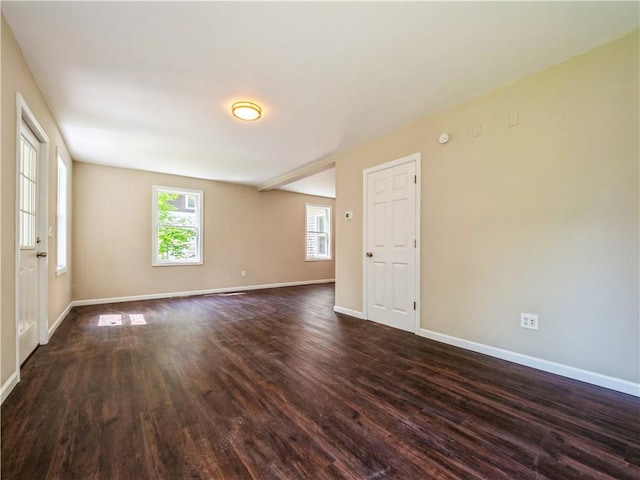 spare room with dark hardwood / wood-style flooring