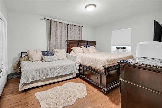 bedroom featuring cooling unit and light hardwood / wood-style flooring