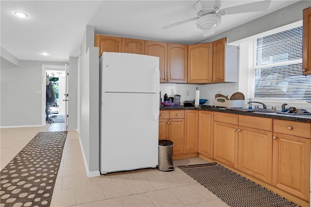 kitchen with light tile patterned floors, white fridge, ceiling fan, and a healthy amount of sunlight