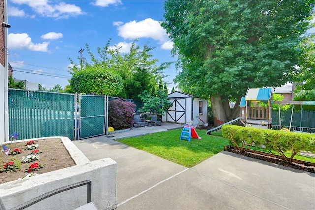 view of yard featuring a patio area and a storage shed