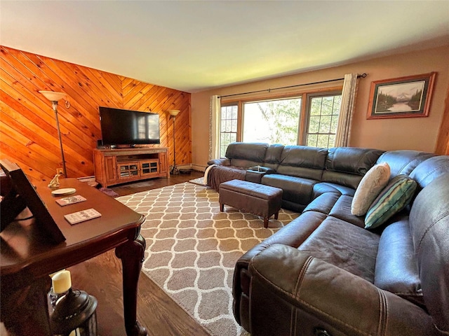 living room with hardwood / wood-style flooring and wood walls