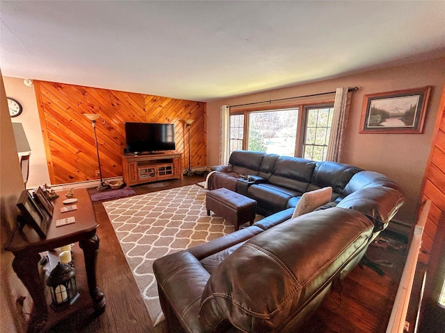 living room with hardwood / wood-style floors and wooden walls