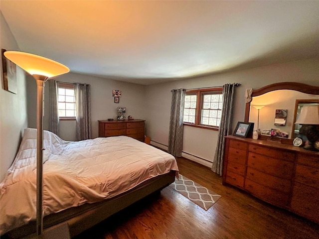 bedroom featuring dark hardwood / wood-style flooring and a baseboard radiator