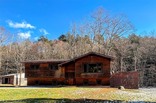 cabin with a front lawn and a deck