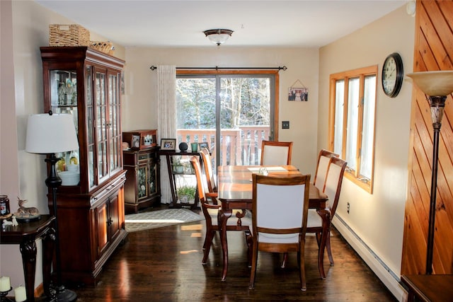 dining area with dark hardwood / wood-style floors and a baseboard heating unit